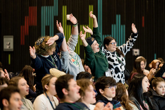 Photo of a group of teens in NFTY standing and waving their arms