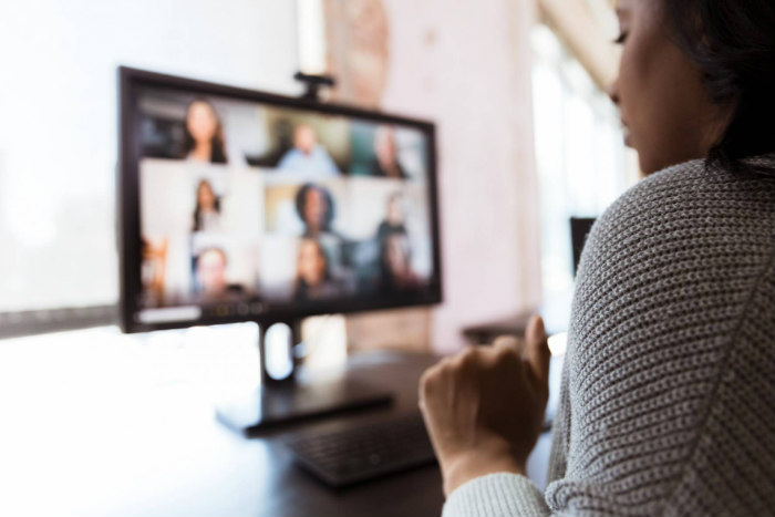 Woman sitting in front of her laptop screen while taking a Zoom call