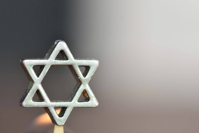 Silver Star of David against a blurred greyish background