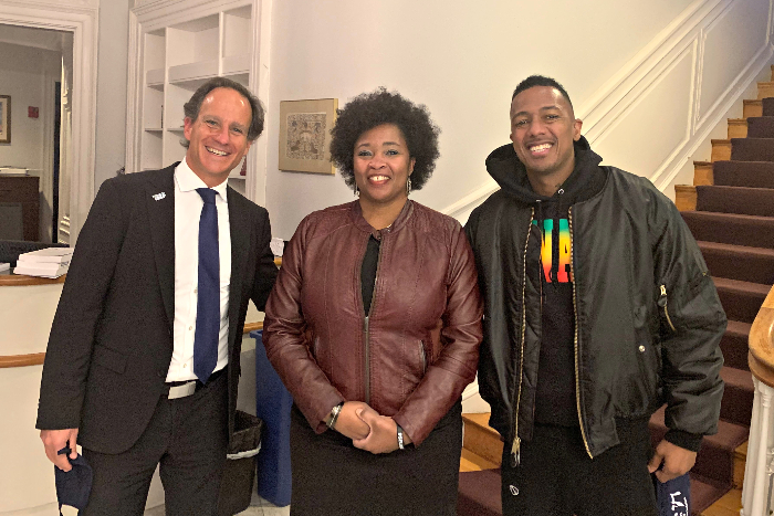 Rabbi Jonah Pesner and Yolanda Savage Narva pose with Nick Cannon in the foyer of the RAC building
