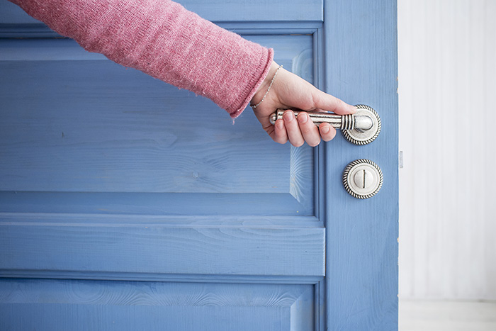 hand opening a door