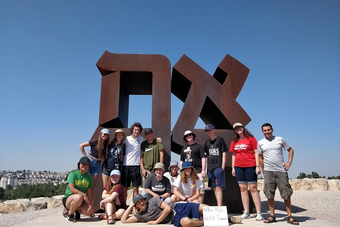 group of heller high students standing infront of a sign that says AHAVAH (love)