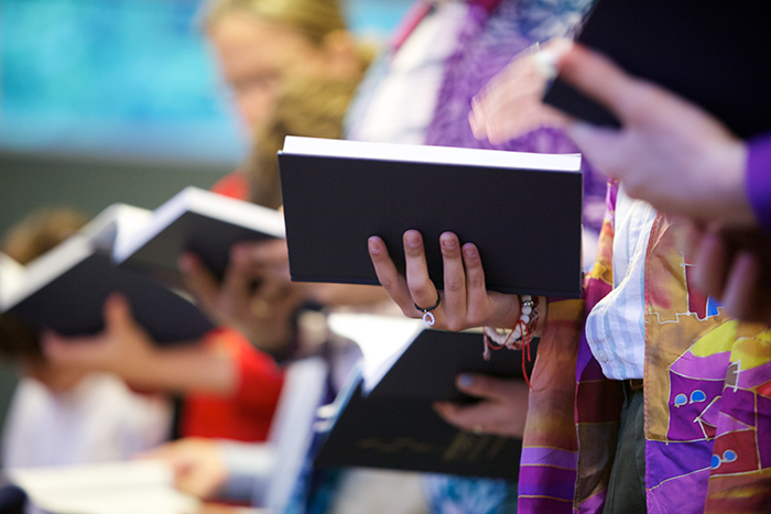 hands holding prayer books at a Reform Jewish service