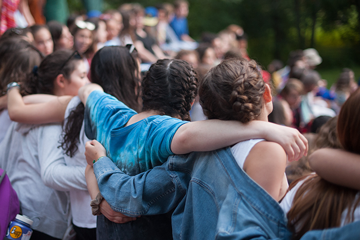 an image of a group of kids with their arms around each other 