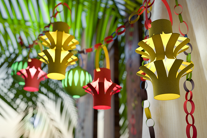 an image of yellow and red paper lantern hanging in the inside of a sukkah