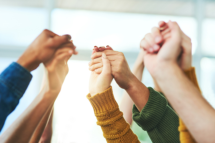 group of people's hands clasping each other