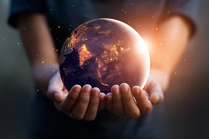 Photo of a person holding Earth in their hands