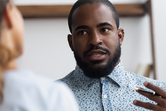 person speaking to a colleague