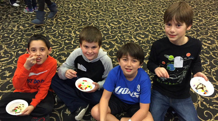 Four boys sitting on the floor