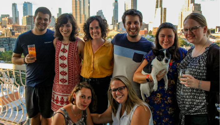 Smiling group of young leaders standing on a balcony together 