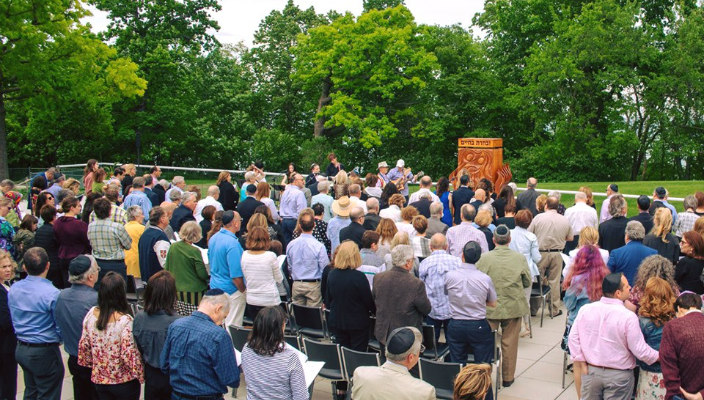 Outdoor Shabbat services surrounded by trees 