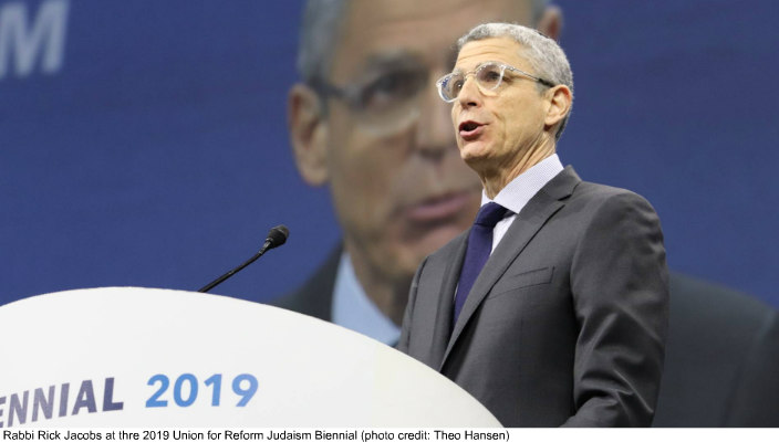 Rabbi Rick Jacobs addresses the URJ Biennial plenary on stage behind a podium