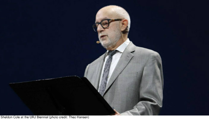 Sheldon Cole stands on the URJ Biennial stage as he presents his Biennial address