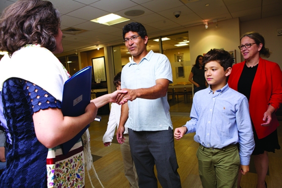 an image of a woman shaking a man's hand