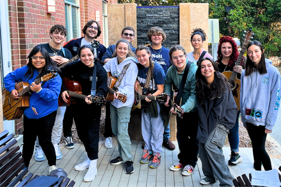 an image of a group of teens, some with guitars