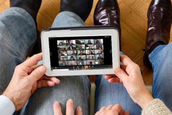 Couple looking at Zoom meeting on tablet