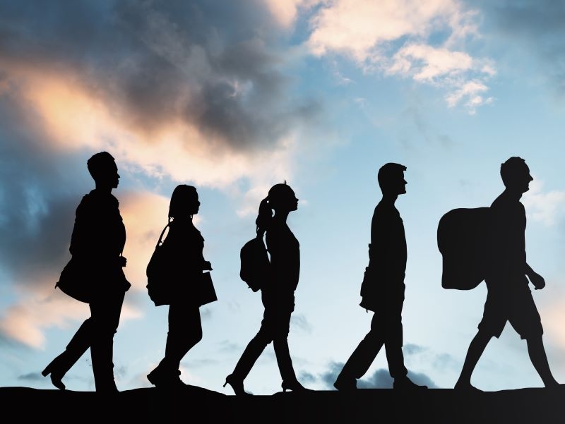 people walking with a blue sky in the background