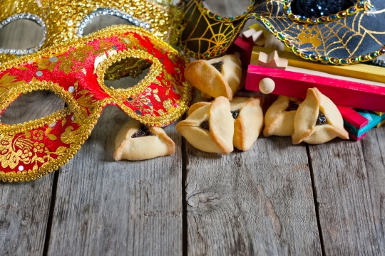 mask, hammantaschen, and grogger on wood