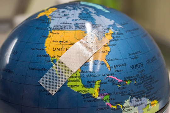 an image of a glode with a bandaid over the United States