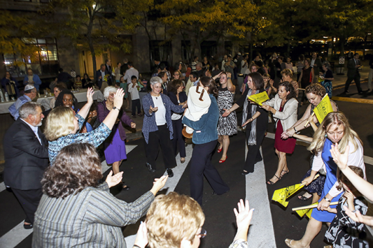 Photo of a group of people dancing with the Torah in the streets of Boston for Simchat Torah