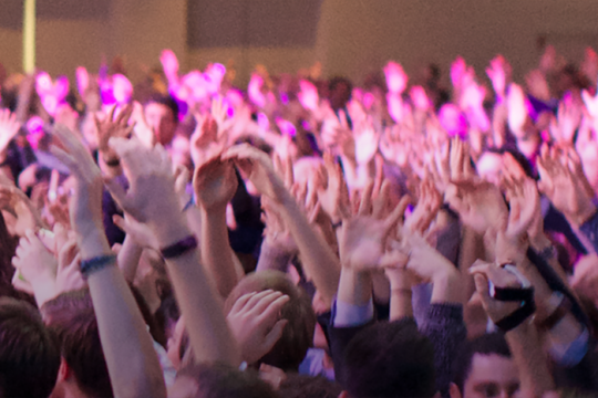 people dancing with hands in the air