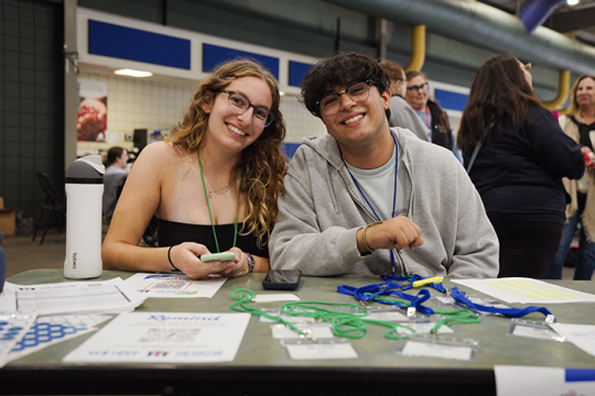 Photo of two teens sitting at a table