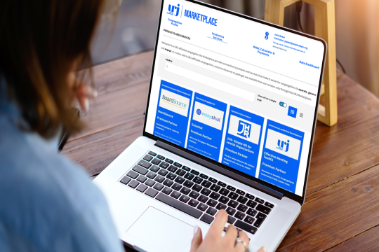 person looking at laptop screen with the URJ Marketplace website displayed