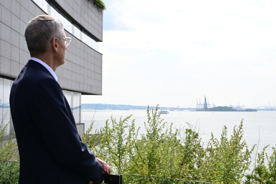 Rabbi Rick Jacobs looking out on NYC Harbor and the Statue of Liberty