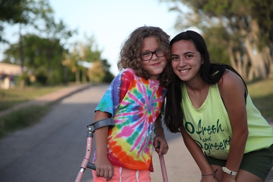 counselor and URJ camper using crutches 