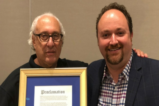 Steve Portnoy and Steve Fletcher with the proclamation from the city of Minneapolis