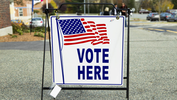 Sign outside polling place that says: Vote Here 