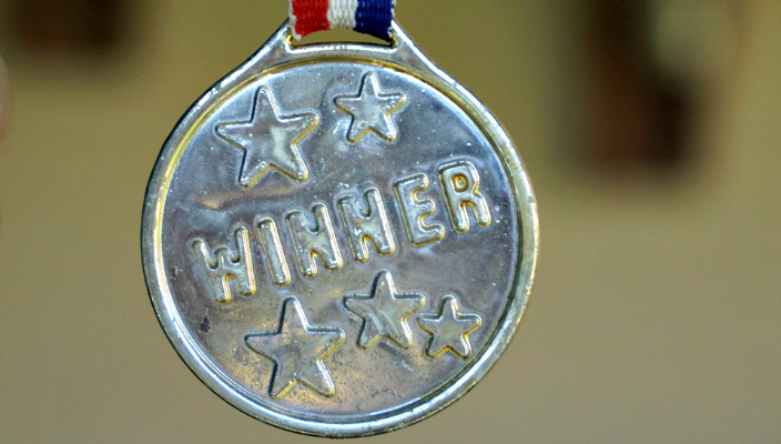 Silver medal with the word WINNER on it